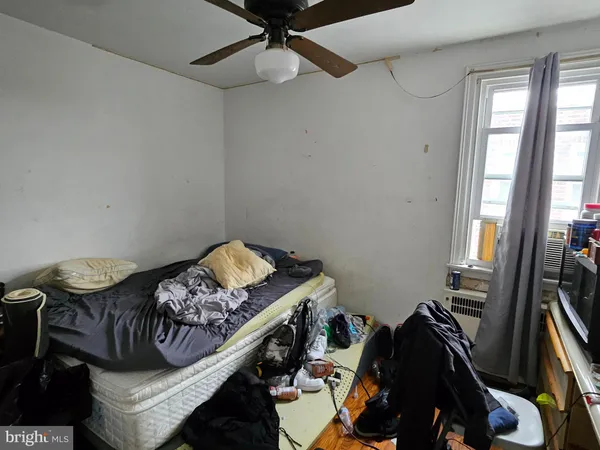 a bed sitting in a bedroom next to a window