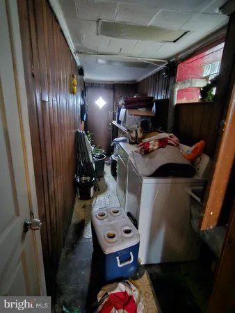 a utility room with dryer washer and a view of living room