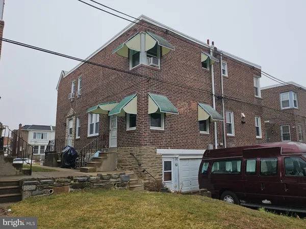 a view of a big house with a yard