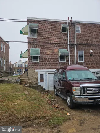 a car parked in front of a brick house