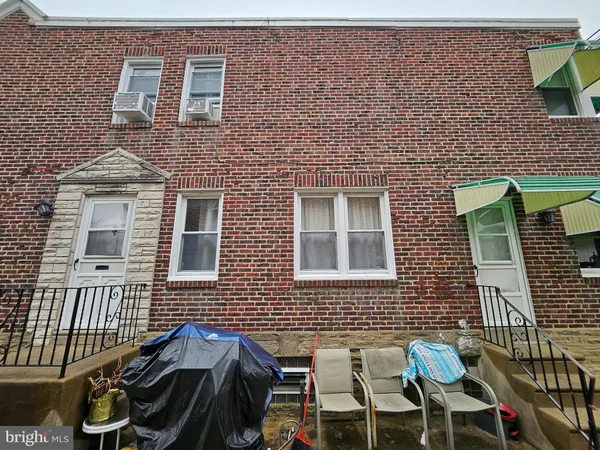 a view of a brick house with many windows