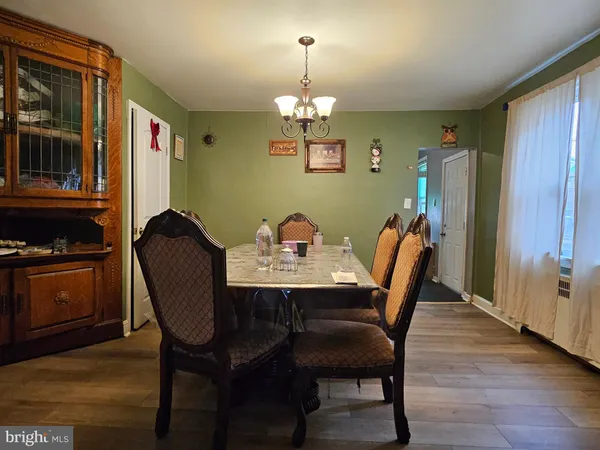 a view of a dining room with furniture and chandelier