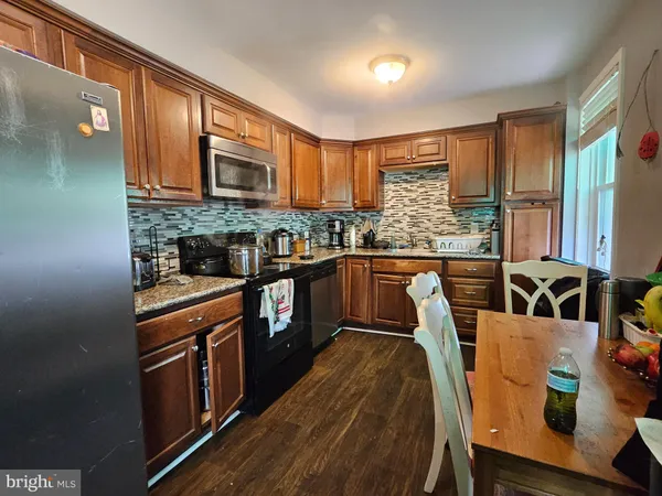 a kitchen with stainless steel appliances granite countertop a stove a sink dishwasher and a refrigerator