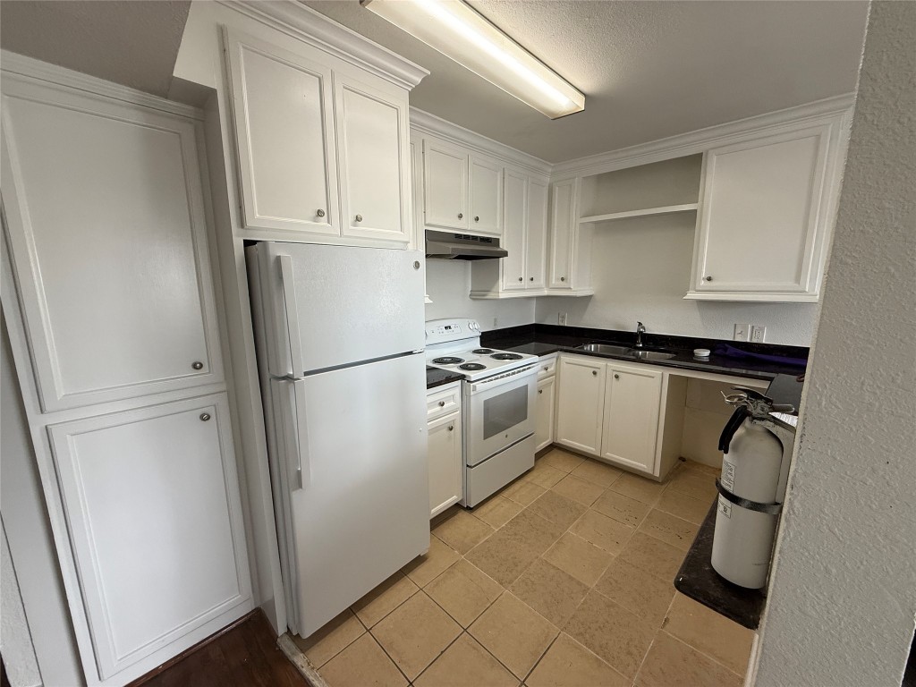 3002 Market Street, Unit 4 Houston, TX 77020 - Photo 4 of 13 a kitchen with white cabinets and white appliances