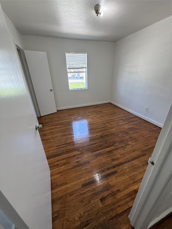 3002 Market Street, Unit 4 Houston, TX 77020 - Photo 8 of 13 a view of an empty room with wooden floor and a window