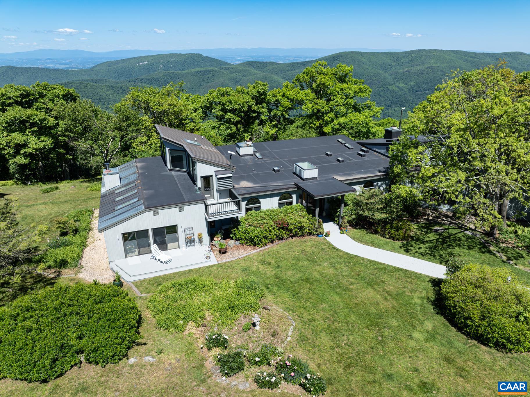 7098 Bucks Elbow Mountain Road Crozet, VA 22932 - Photo 3 of 57 an aerial view of a house with a yard