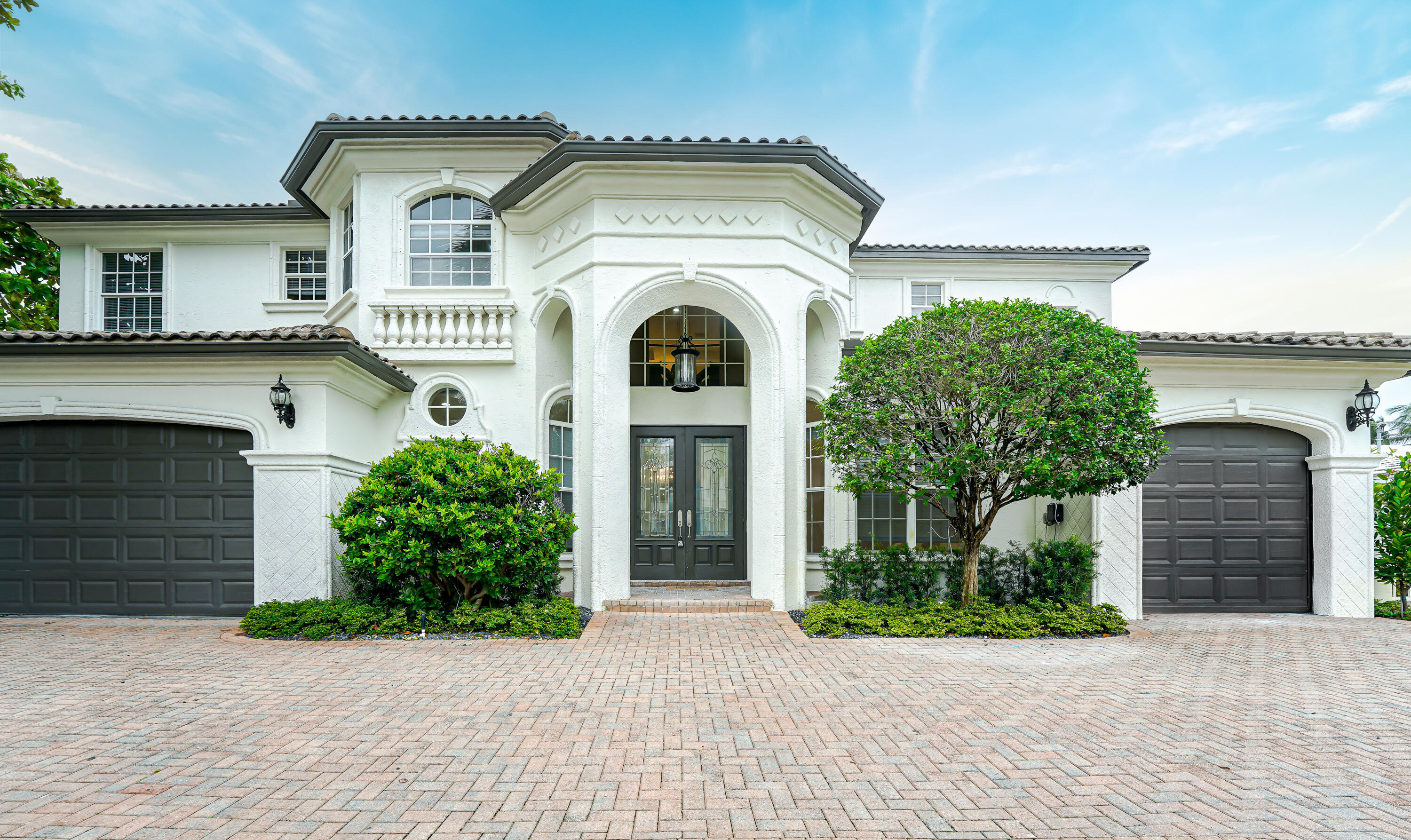 749 Northeast 71st Street Boca Raton, FL 33487 - Photo 2 of 43 a front view of a house with garden