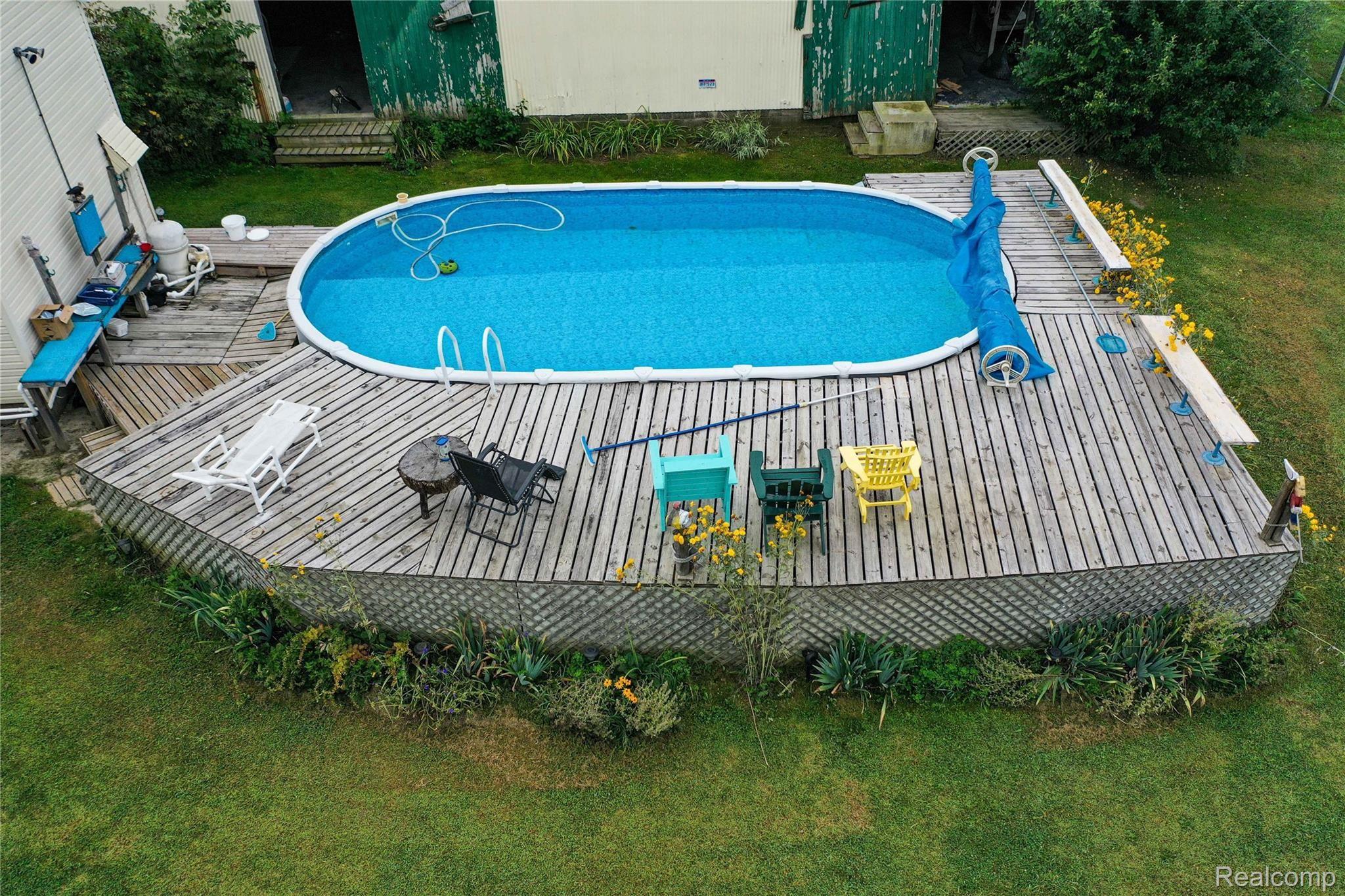 8280 Farley Road Pinckney, MI 48169 - Photo 36 of 39 36-15x30 heated pool with 400,000 BTU Natural gas heater . large sun deck