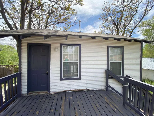 a view of a house with a door and wooden floor