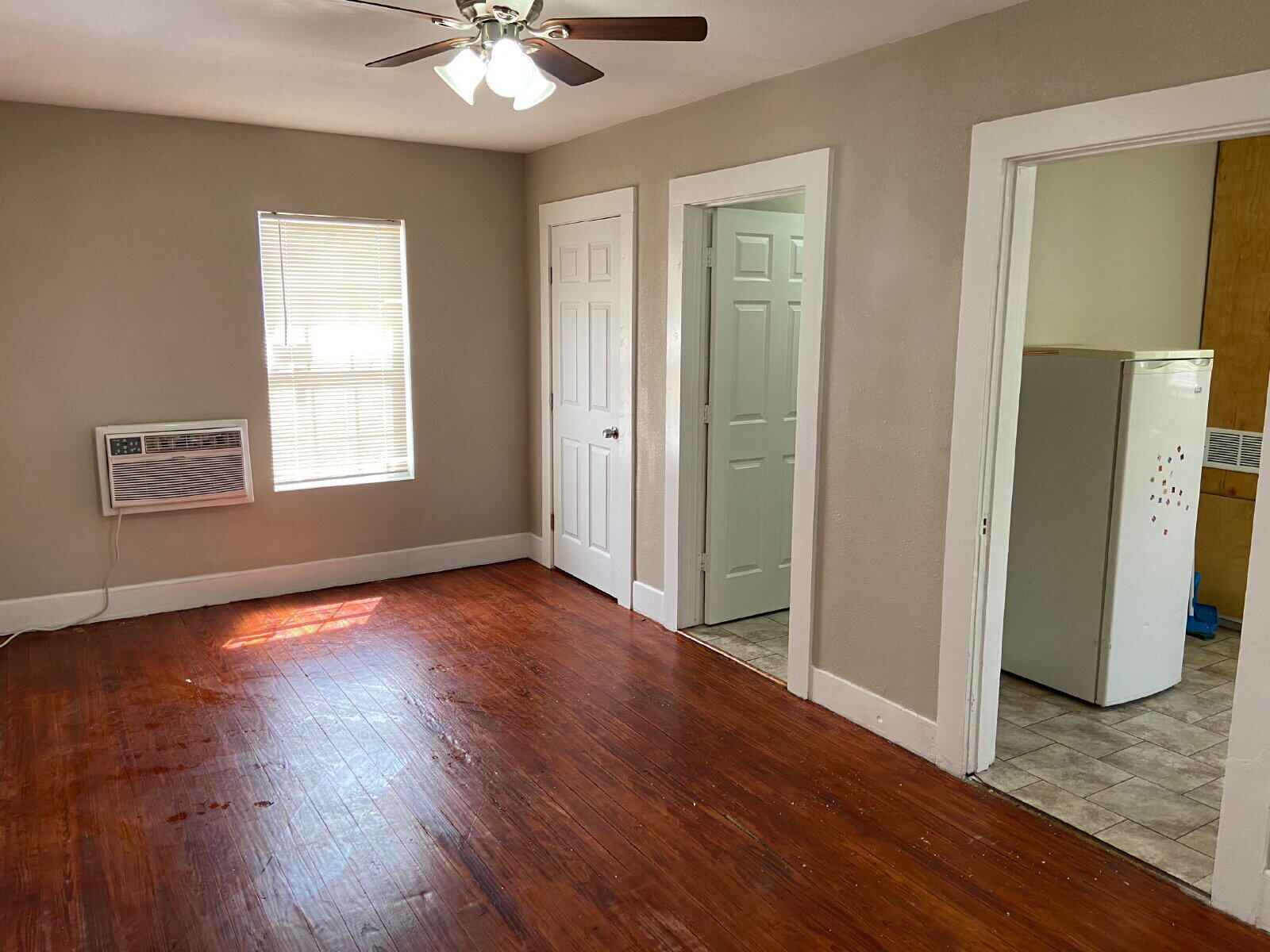 1909 16th Street, Unit REAR Lubbock, TX 79401 - Photo 3 of 9 a view of an empty room with window and wooden floor