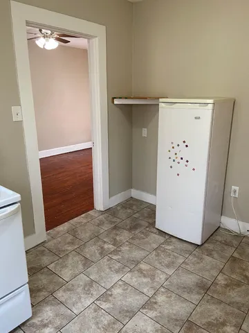 an empty room with a door and mirror