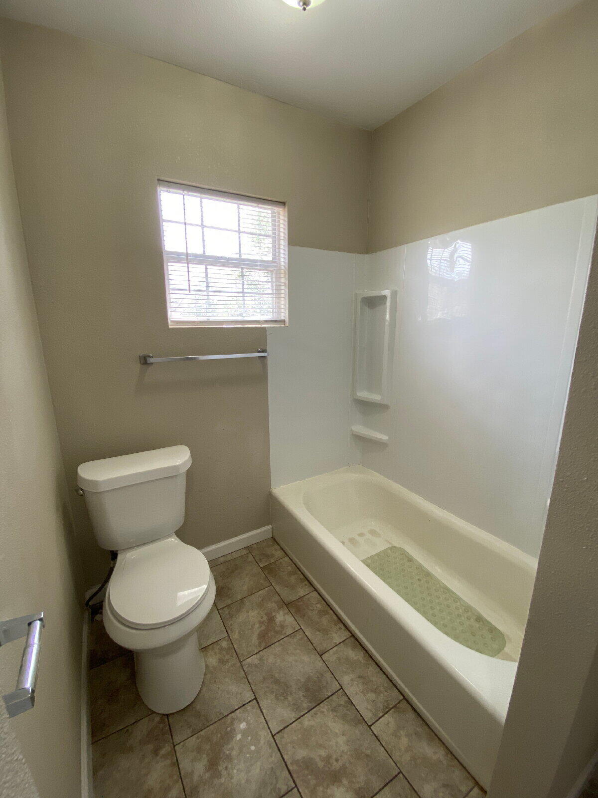 1909 16th Street, Unit REAR Lubbock, TX 79401 - Photo 9 of 9 a bathroom with a toilet sink and bathtub