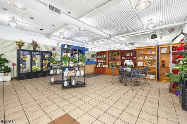 a view of a room with lots of tables and chairs