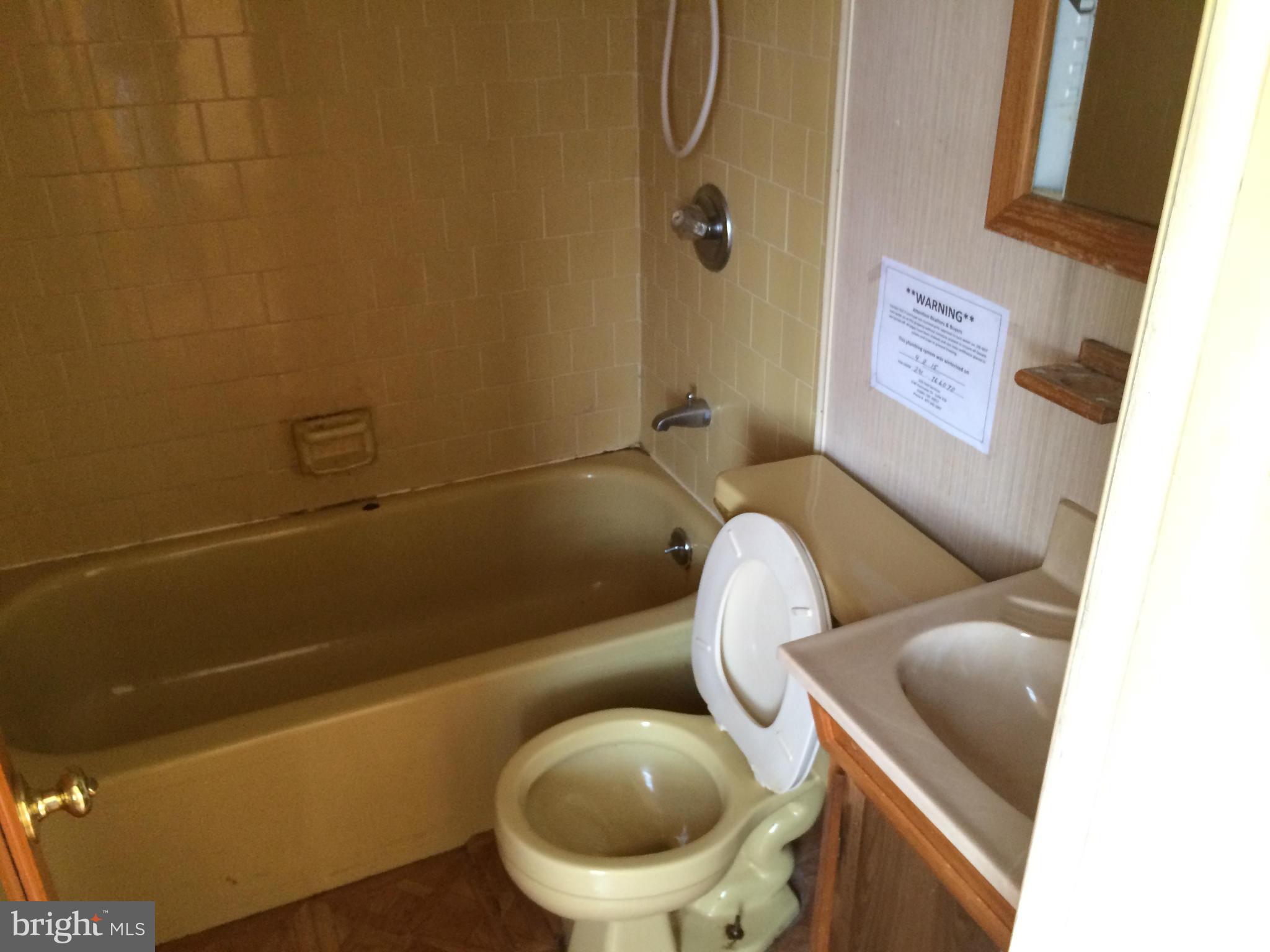 4425 Eldone Road Baltimore, MD 21229 - Photo 3 of 11 a toilet sitting next to a bathroom
