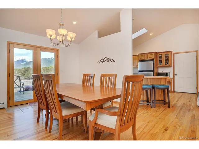 a view of a dining room with furniture wooden floor and chandelier