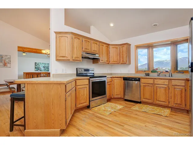 a kitchen with stainless steel appliances granite countertop a stove a sink dishwasher and a refrigerator