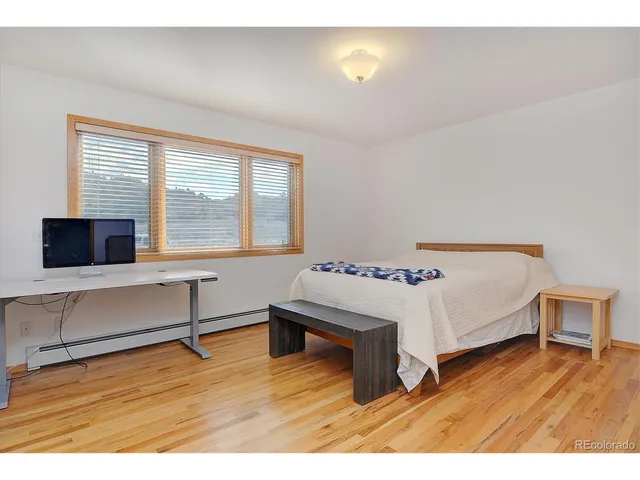 a living room with a bed furniture and a flat screen tv