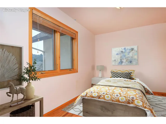 a bedroom with a bed and a large mirror