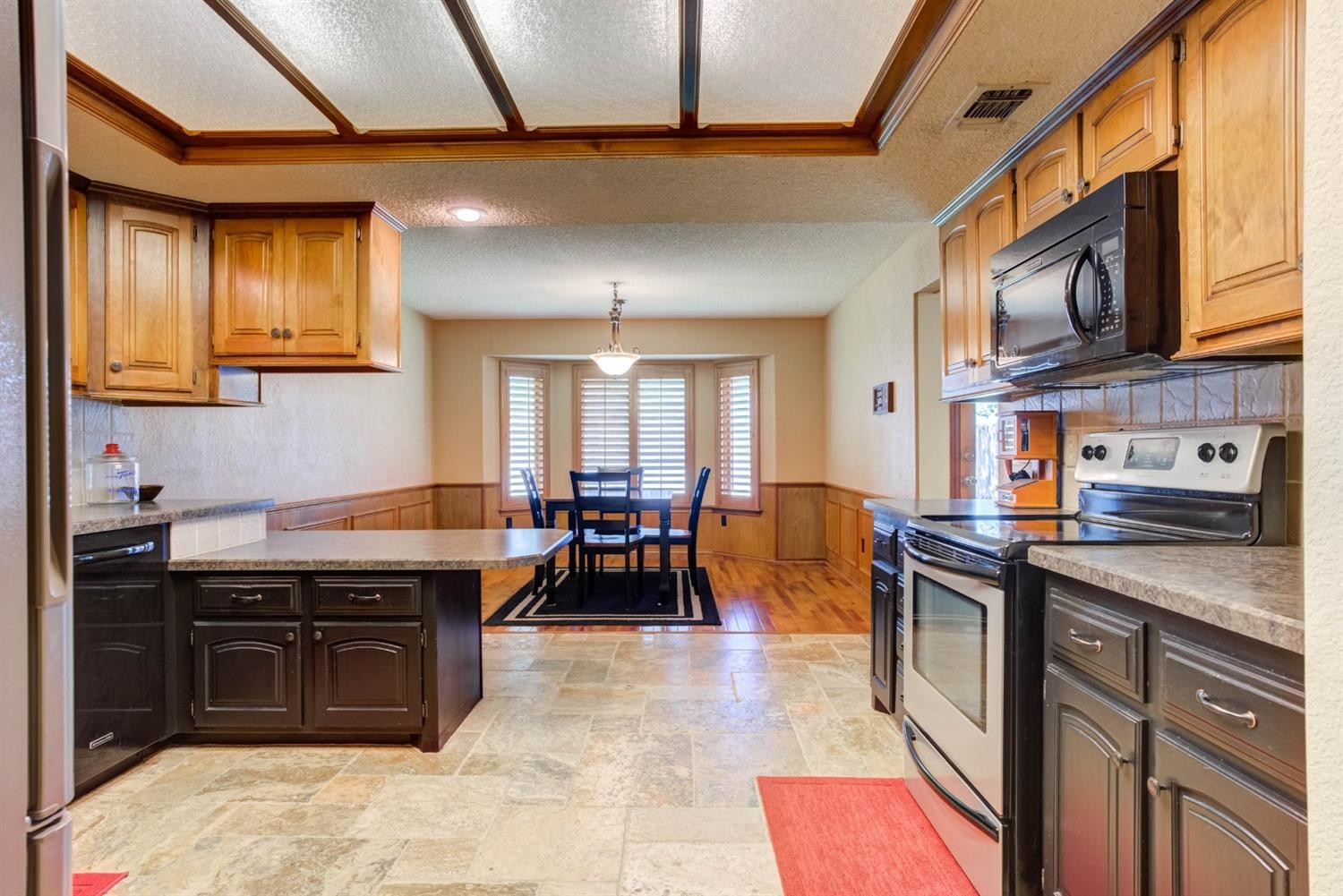 5304 90th Street Lubbock, TX 79424 - Photo 12 of 39 a kitchen with stainless steel appliances granite countertop a stove and a sink