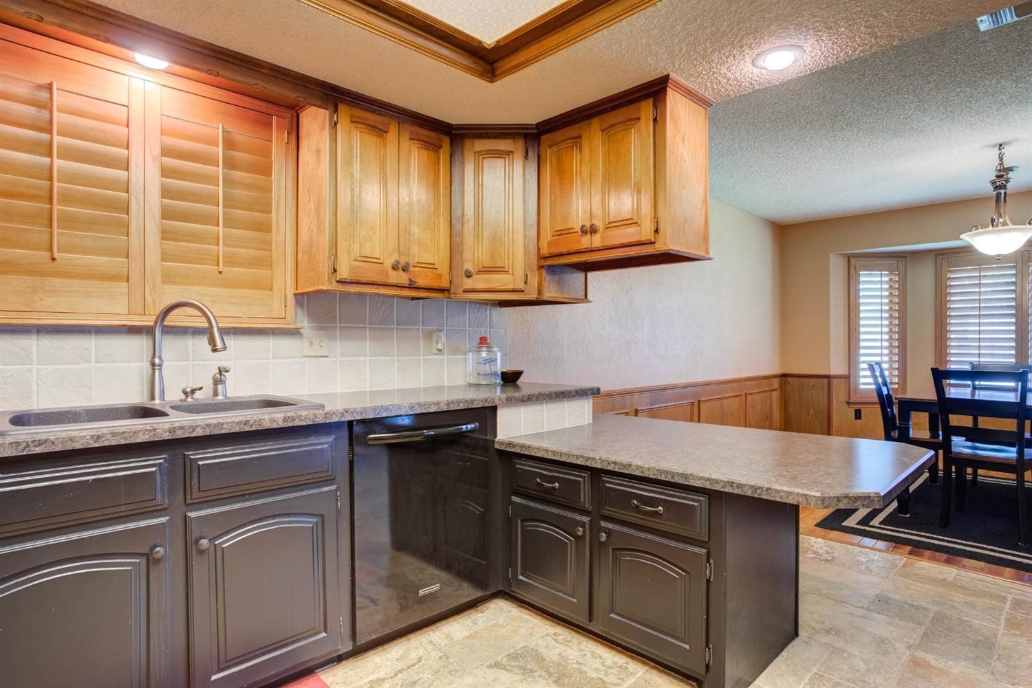 5304 90th Street Lubbock, TX 79424 - Photo 13 of 39 a kitchen with kitchen island granite countertop a sink counter top space and cabinets