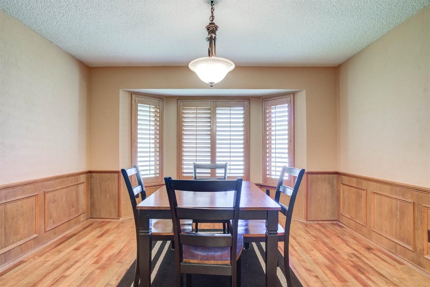 5304 90th Street Lubbock, TX 79424 - Photo 16 of 39 a view of a dining room with furniture window and wooden floor