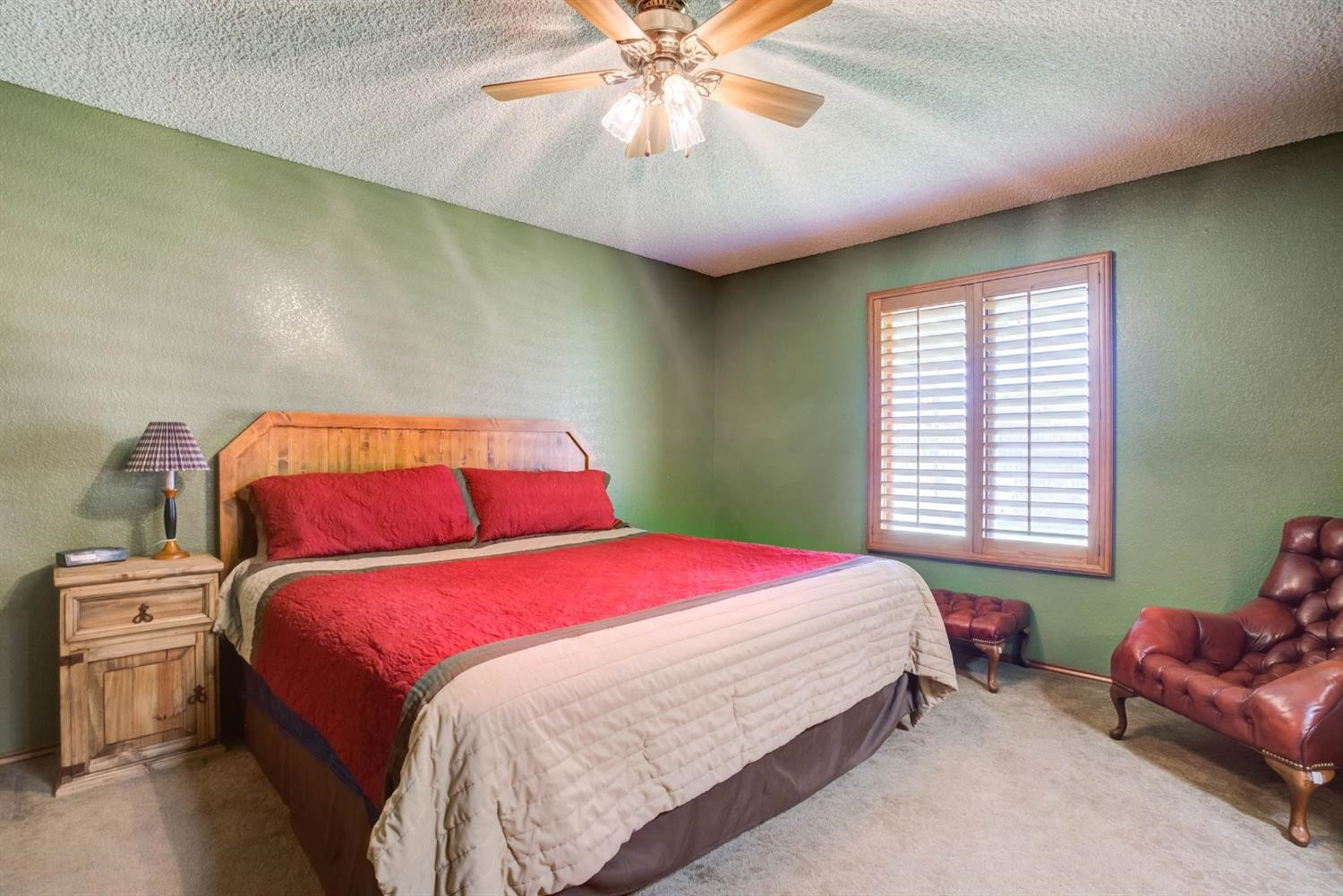 5304 90th Street Lubbock, TX 79424 - Photo 18 of 39 a bedroom with a bed and a chandelier