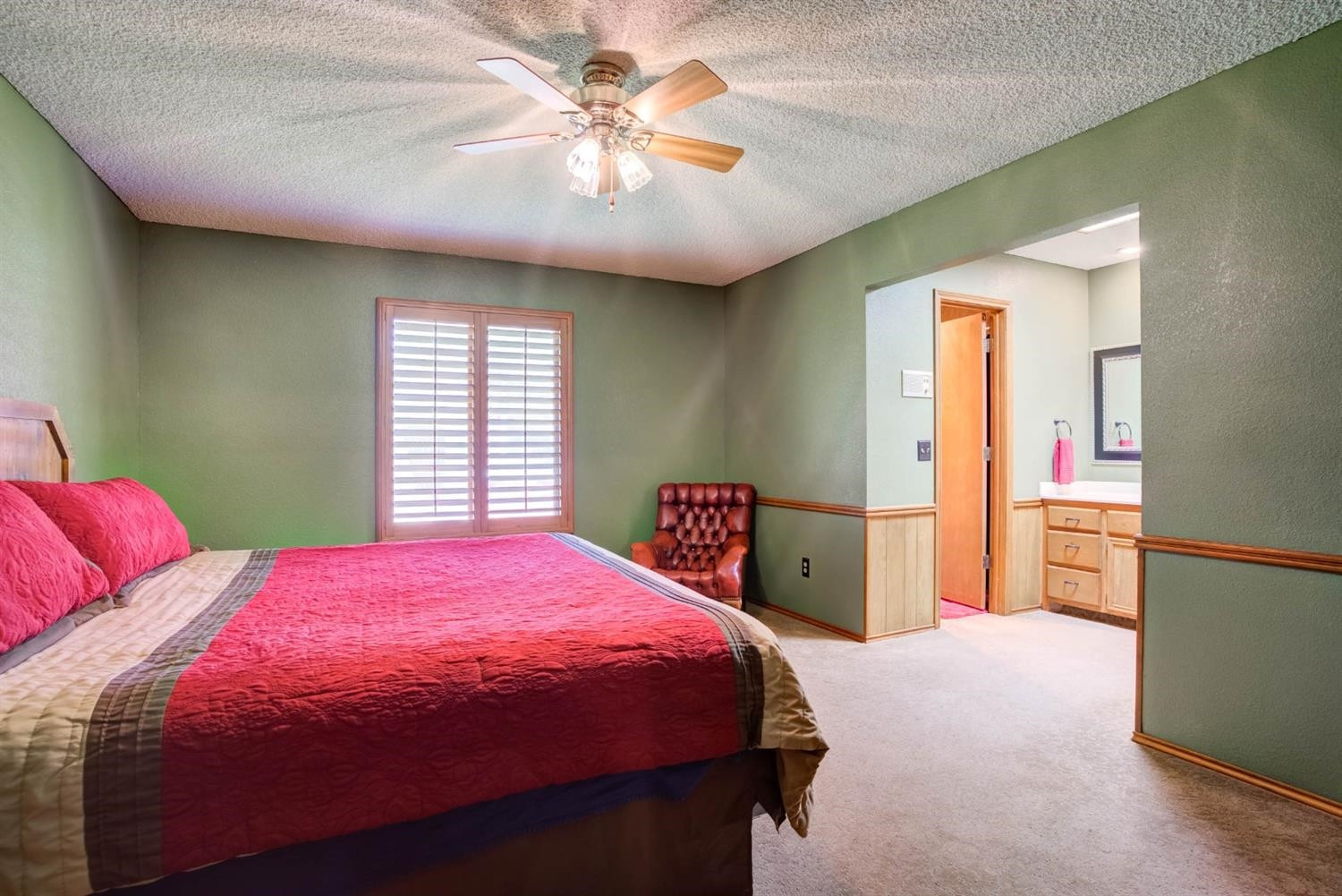 5304 90th Street Lubbock, TX 79424 - Photo 19 of 39 a bedroom with a bed and a chandelier