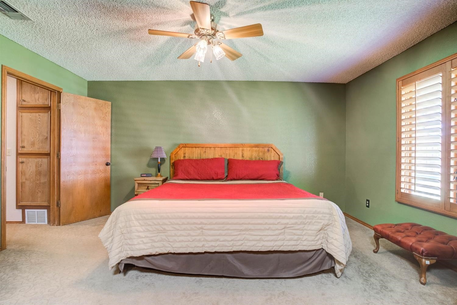 5304 90th Street Lubbock, TX 79424 - Photo 20 of 39 a bedroom with a bed and a chandelier