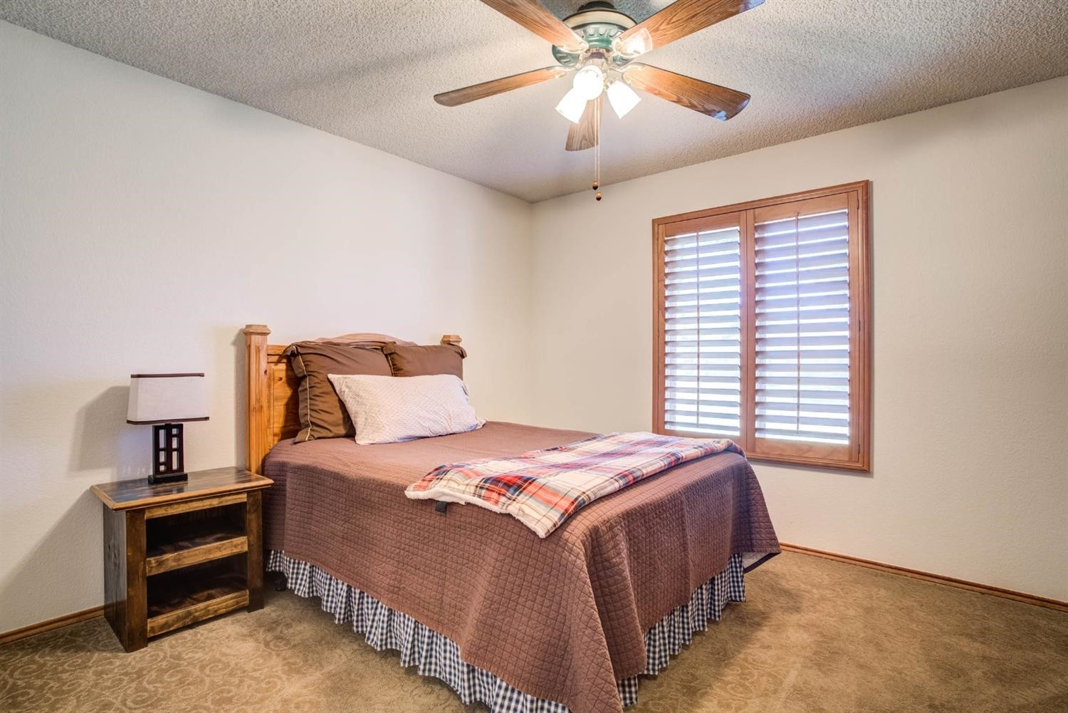 5304 90th Street Lubbock, TX 79424 - Photo 24 of 39 a bedroom with a bed and a chandelier