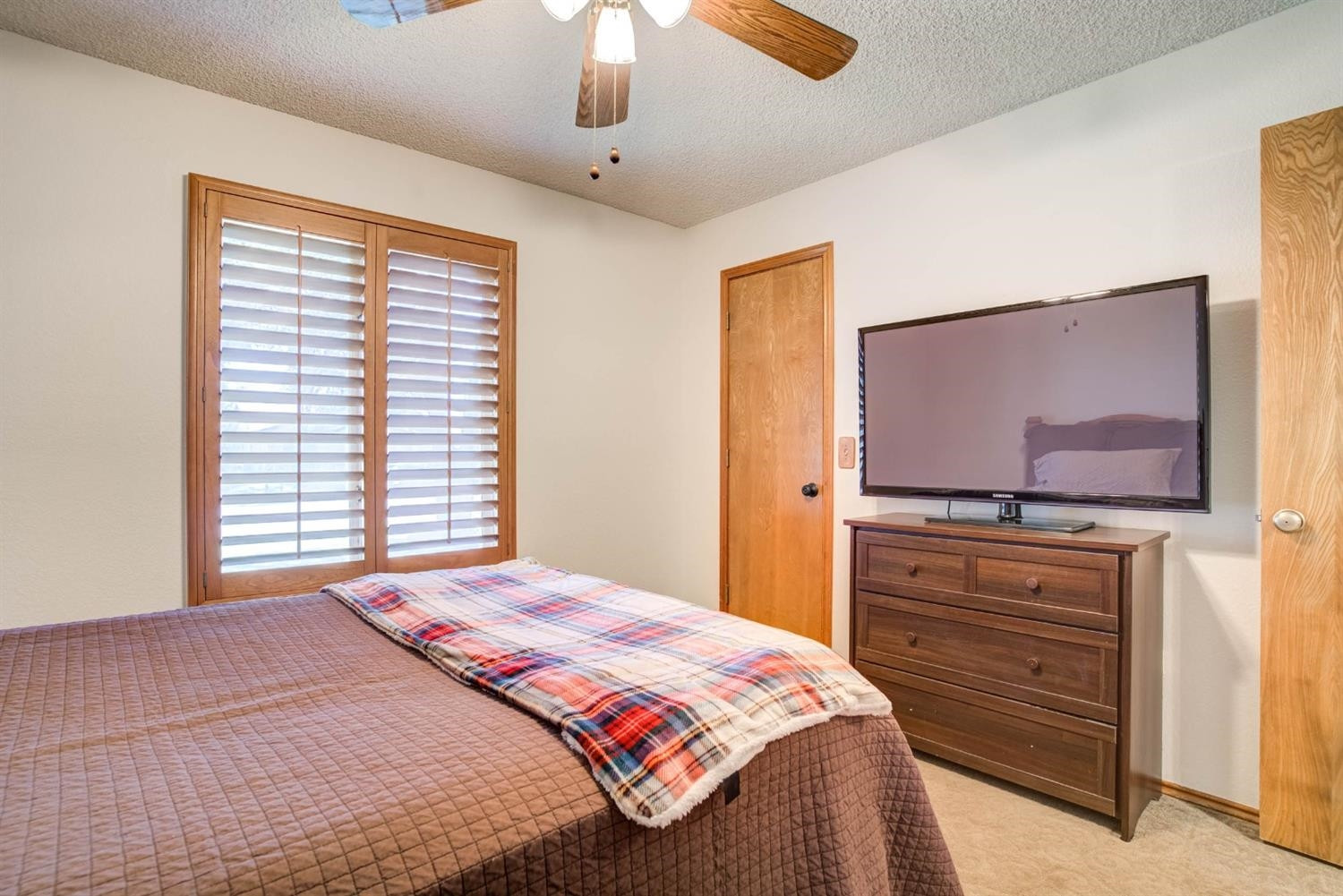 5304 90th Street Lubbock, TX 79424 - Photo 25 of 39 a bedroom with a bed and a dresser