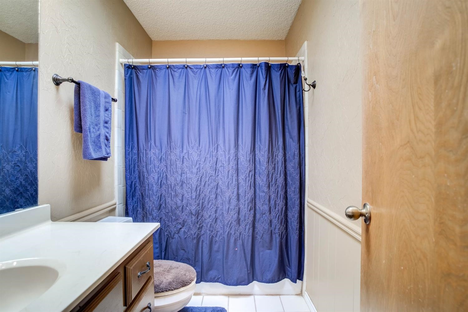 5304 90th Street Lubbock, TX 79424 - Photo 26 of 39 a bathroom with a sink and a mirror