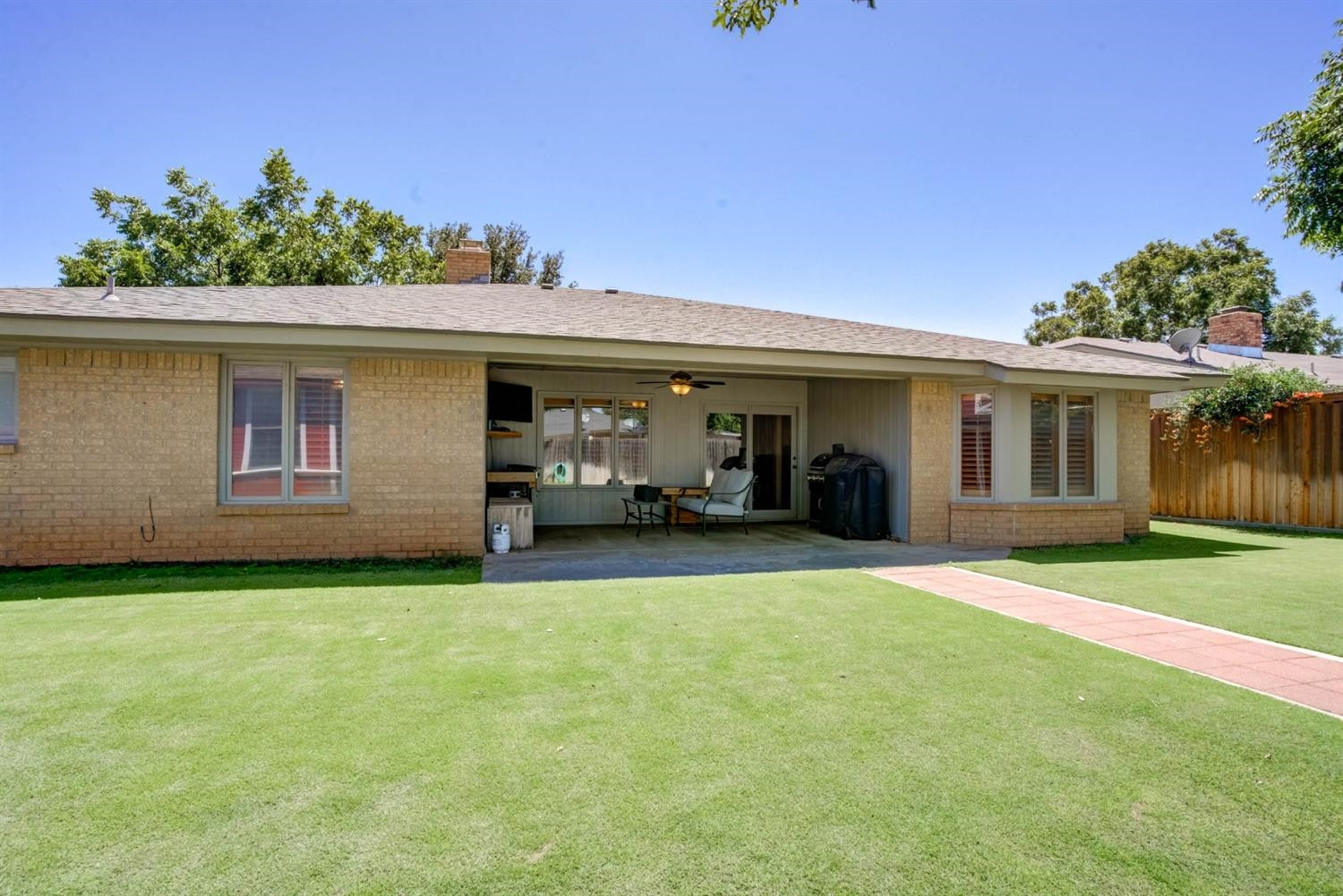 5304 90th Street Lubbock, TX 79424 - Photo 33 of 39 a view of a house with backyard and a tree