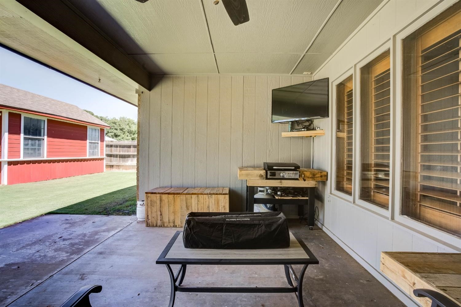 5304 90th Street Lubbock, TX 79424 - Photo 37 of 39 a living room with a patio furniture and a flat screen tv