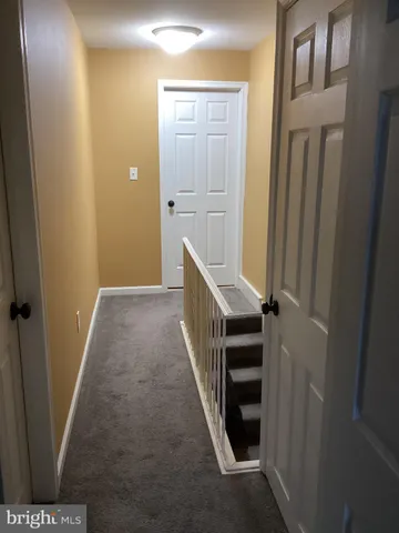 a view of a hallway with staircase