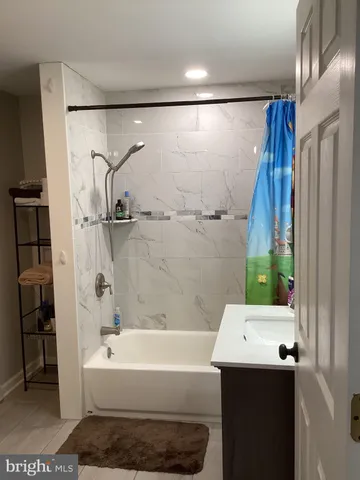 a bathroom with a bathtub and a shower