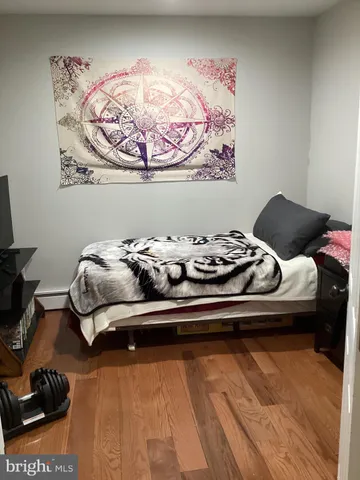 a bedroom with a bed and painting on the wall