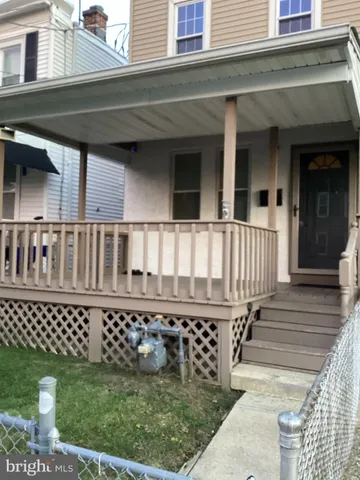 a view of a house with wooden deck