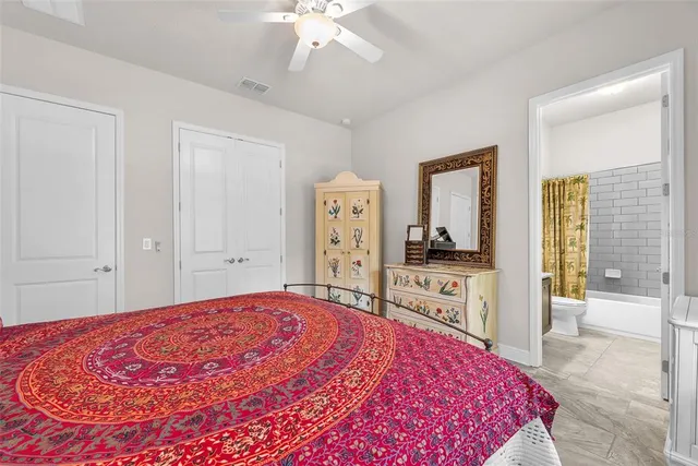 a living room with furniture and a ceiling fan