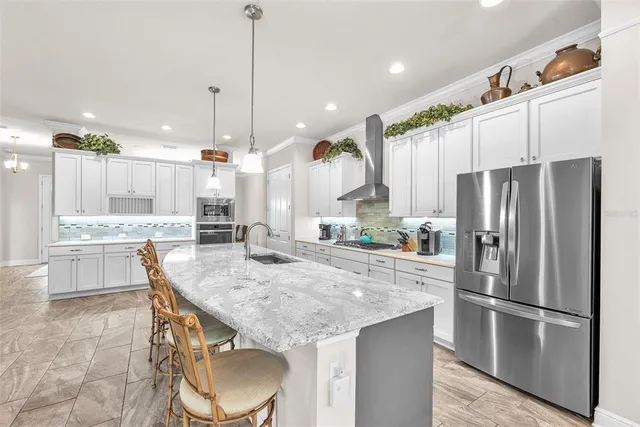 a large kitchen with a table and chairs