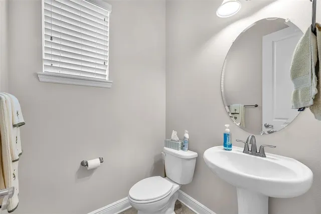 a bedroom with a bed and large windows