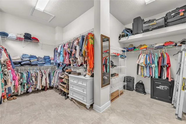 a dining room with furniture large windows and a rug