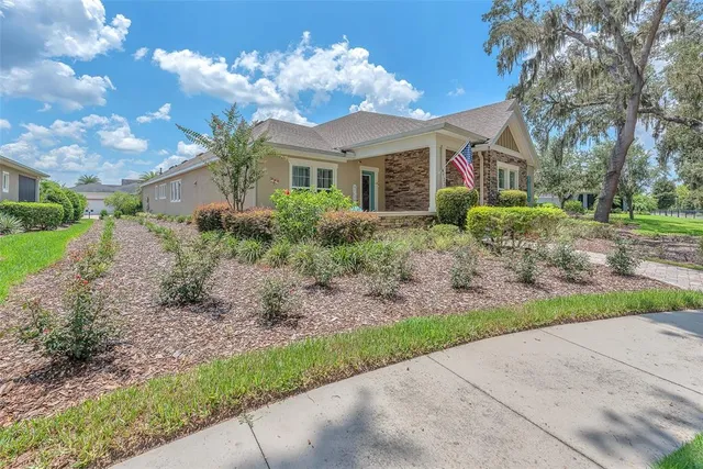 a view of a house with a yard and garden