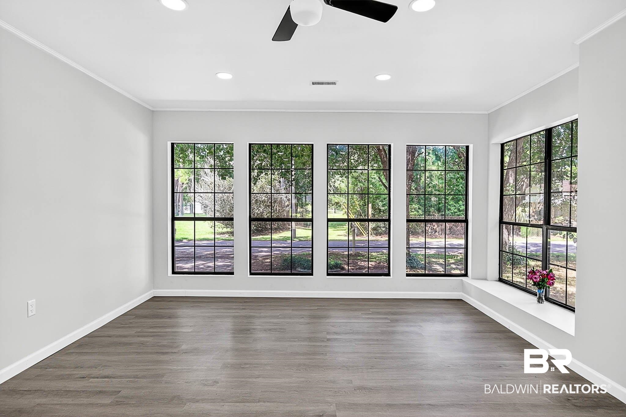 101 Terry Avenue Brewton, AL 36426 - Photo 27 of 48 Spare room with crown molding, dark wood finished floors, recessed lighting, and ceiling fan