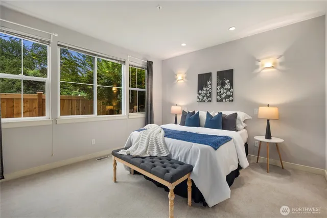 a bedroom with a bed chair and window