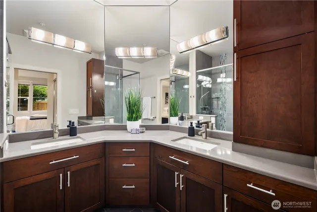 a bathroom with a double vanity sink and a mirror