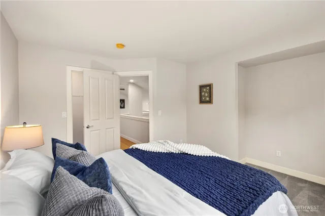 a spacious bedroom with a bed and closet