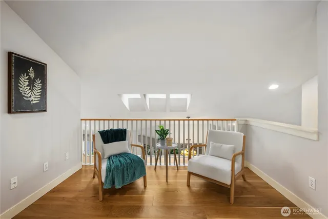 a bedroom with furniture and wooden floor