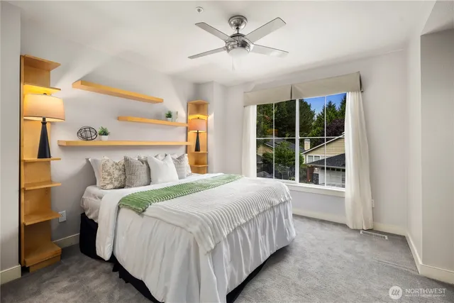 a bedroom with a large bed and a large window