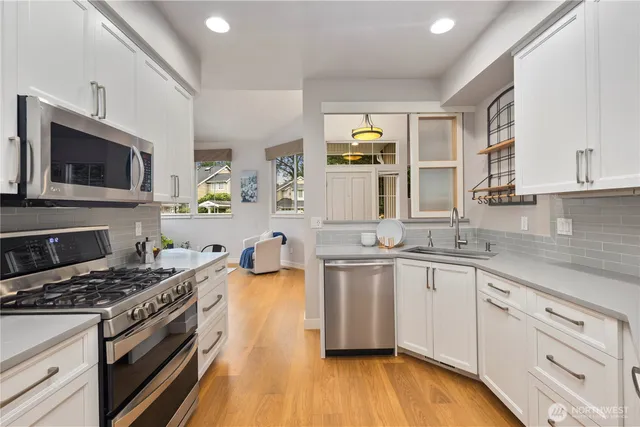a kitchen with a sink a stove and cabinets