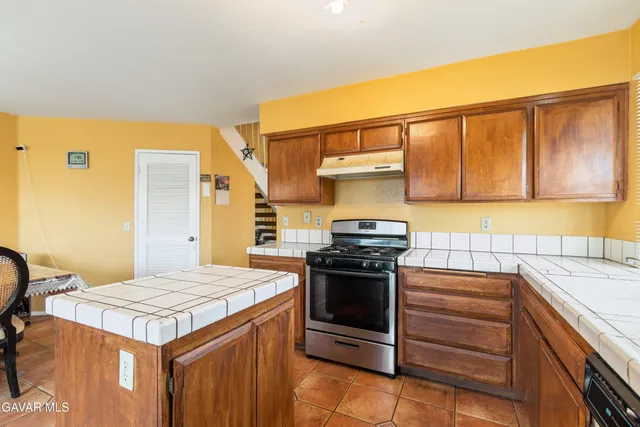 a kitchen with a stove and a sink
